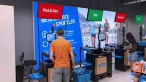 The image shows customers at the self-Checkout counters at Decathlon to improve in-store experiences