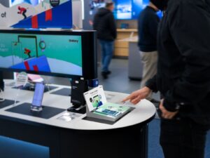 The image shows Interactive Product Demonstrations at a Samsung store as one of the retail customer experience examples