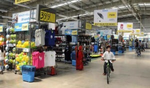 The image shows a kid riding cycle inside Decathlon