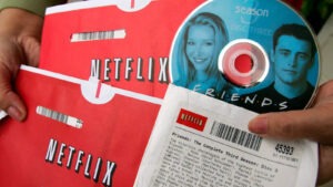 The image shows how Netflix used to send DVDs of movies & TV series over the mail in 1997 as one of the retail customer experience strategy