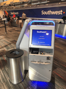 The image shows self-service kiosks of Southwest Airlines