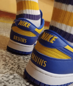 The image shows a blue and yellow Nike shoe that has been customized by the customer.
