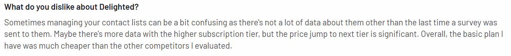 The image shows a con of Delighted on the G2 platform about how confusing it can be when it comes to managing contact lists.