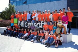 The image shows happy employees of Microsoft