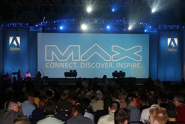 An Image that shows a glimpse from Adobe Max Event where a crowd can be seen sitting in front of the stage. 
