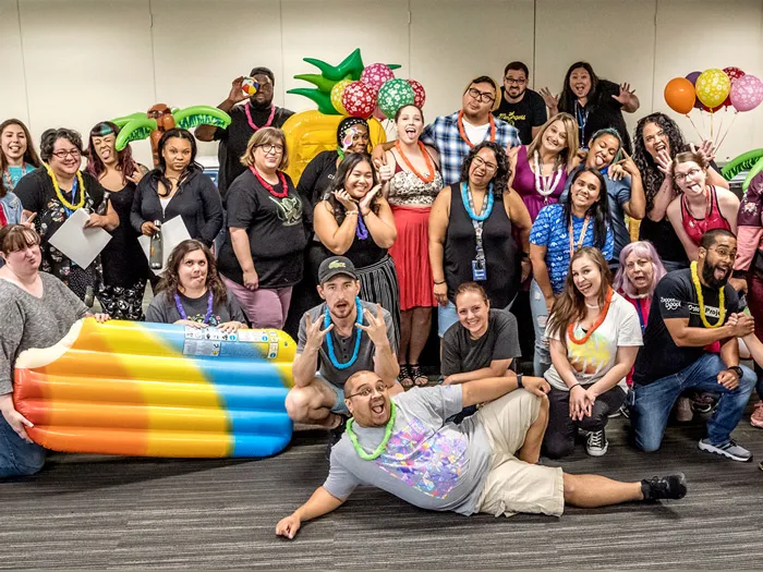 the image shows Zappos’s employees enjoying recreational activities organised by the company. 