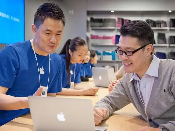 This image is of Apple Genius bar where a user is being assisted by Apple experts in resolving issues.