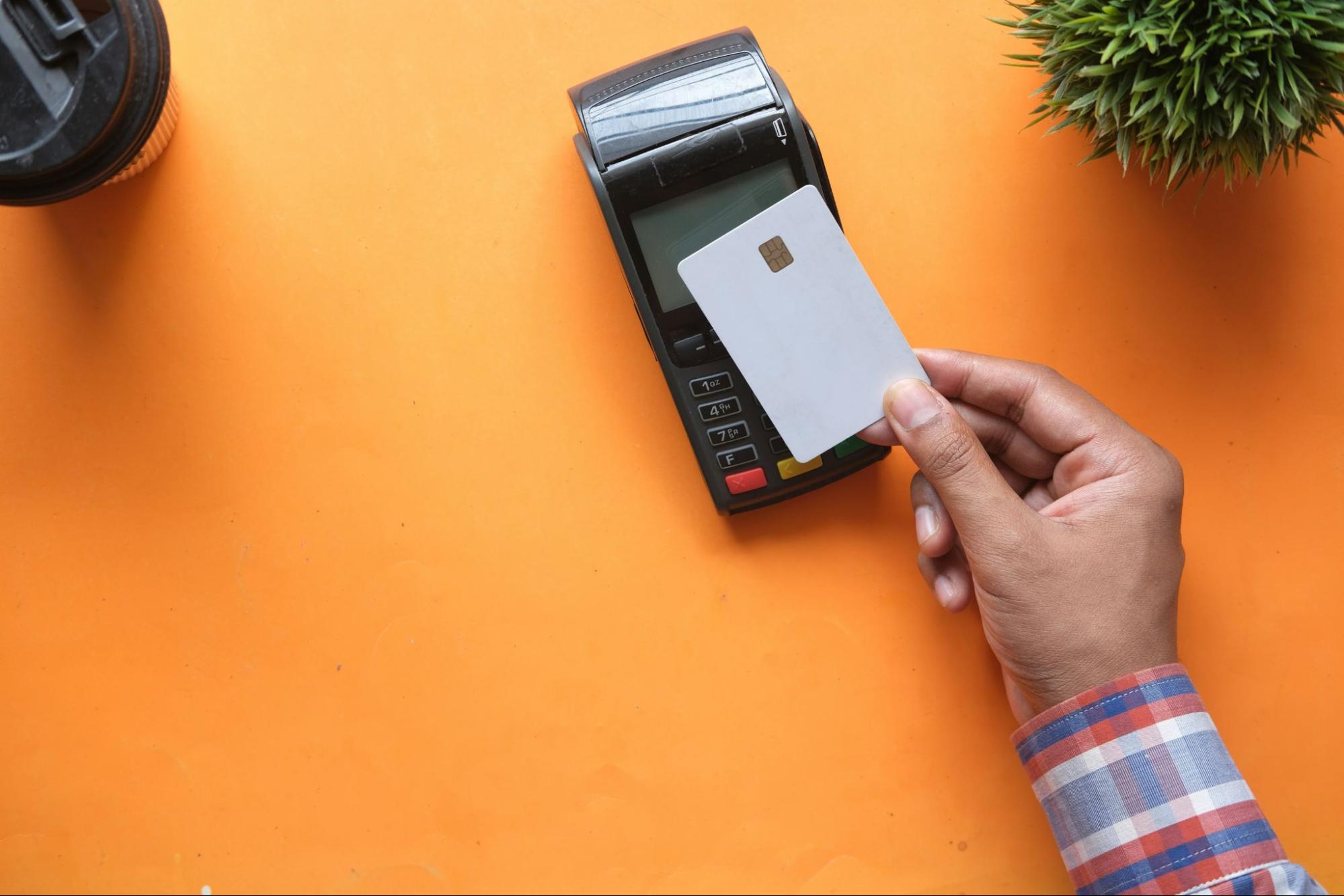 The image shows a credit card inserted into a card reader for a secure payment 