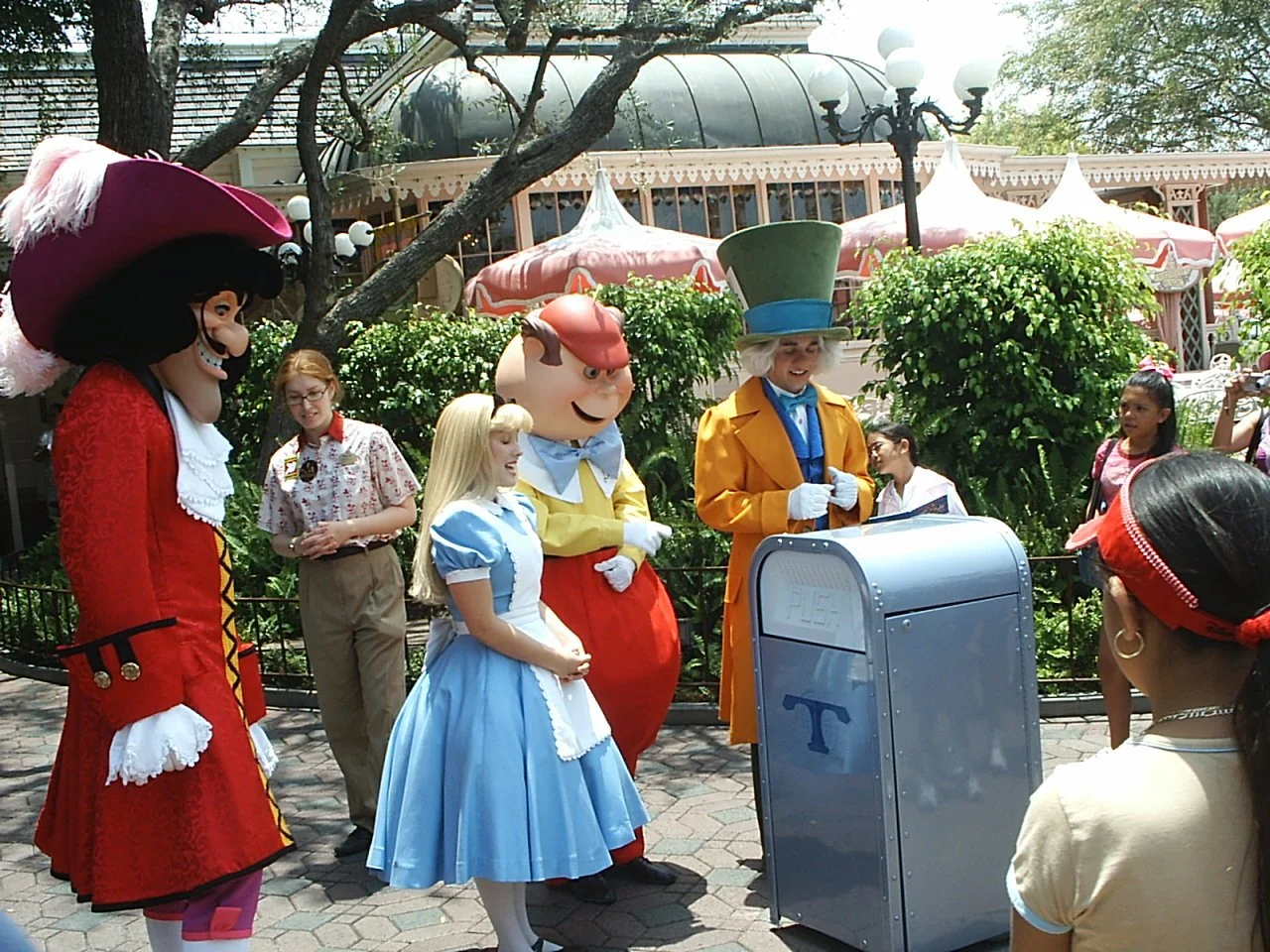 An image showing a Disney character’s team close to a trashcan which is built like a treasure hunt box where they are promoting putting the waste in the trashcan to keep the parks clean 