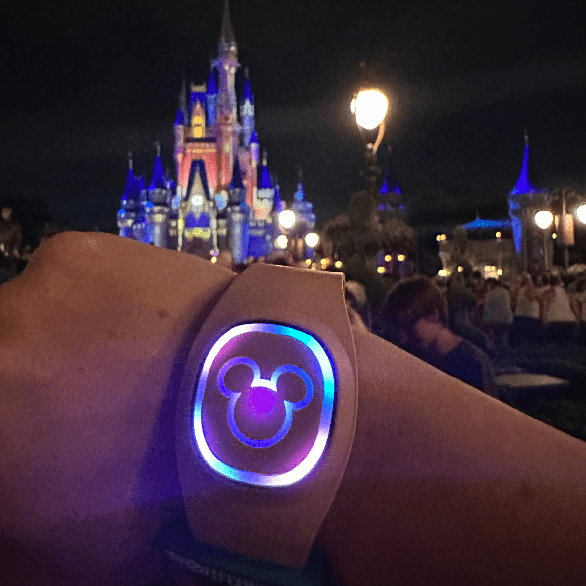 An image showing a person’s hand who has worn a Disney Magicband that can be used for accessing multiple things like room keys, park tickets, payment for food and merchandise, and more in Disney World Parks. 