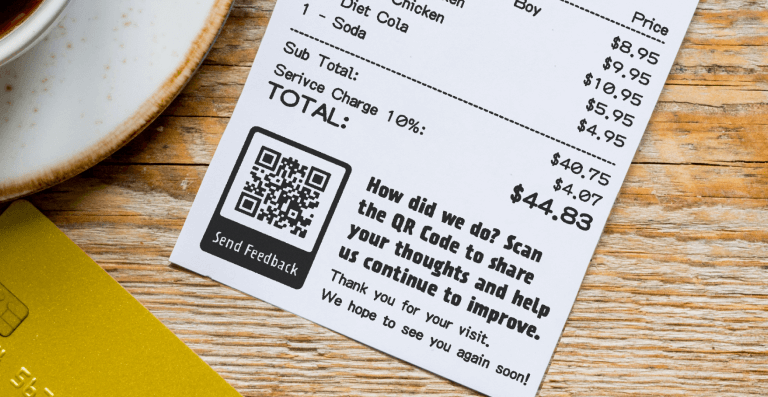 The image shows a QR code survey printed on a receipt of a retail store where customers can scan the code and provide feedback on their experience. 