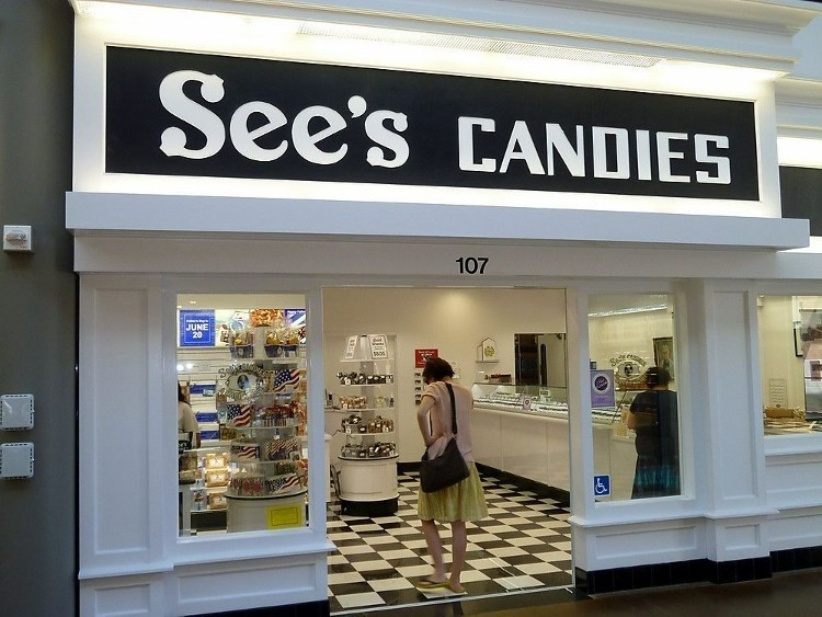 The image shows the inside of one of the See’s Candies stores. 